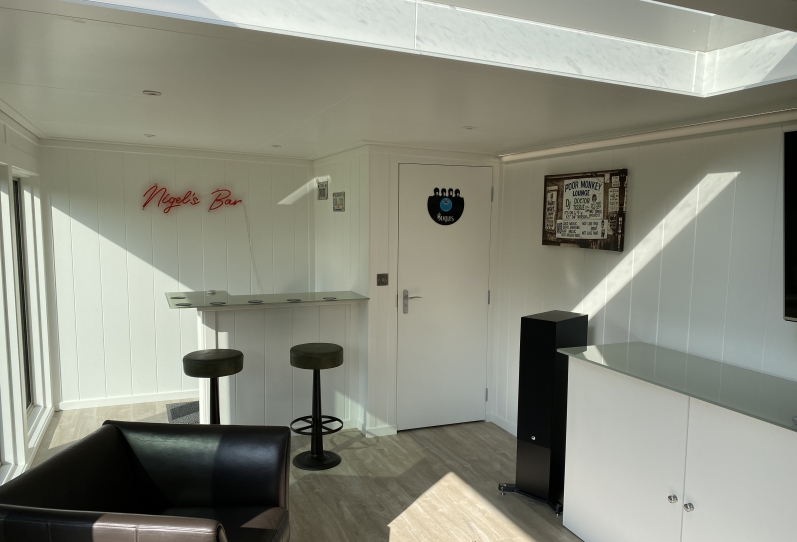man cave, music lounge  with Em-glaze roof light and toilet in london