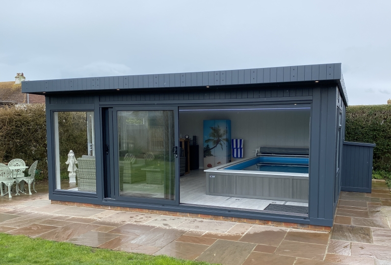 Tri-sliding endless pool room with lounge and bar area in sussex