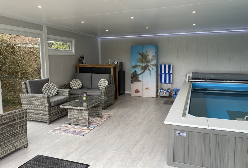 endless pool room with lounge and bar area with wash lighting brighton