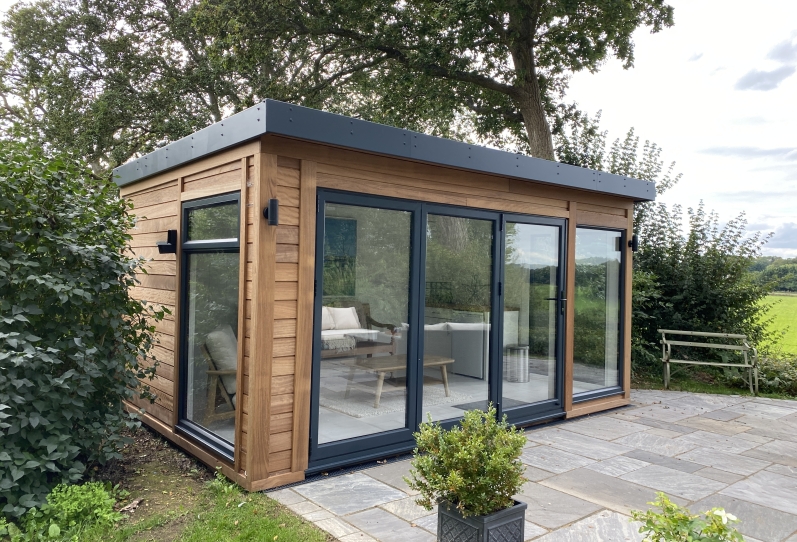 Bifold summer house with Iroko timber cladding and Anthracite doors and fascias in reading