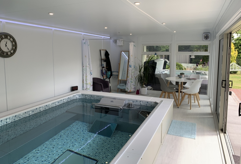 Endless pool room and hot tub canopy , changing area with table and chairs in Hampshire