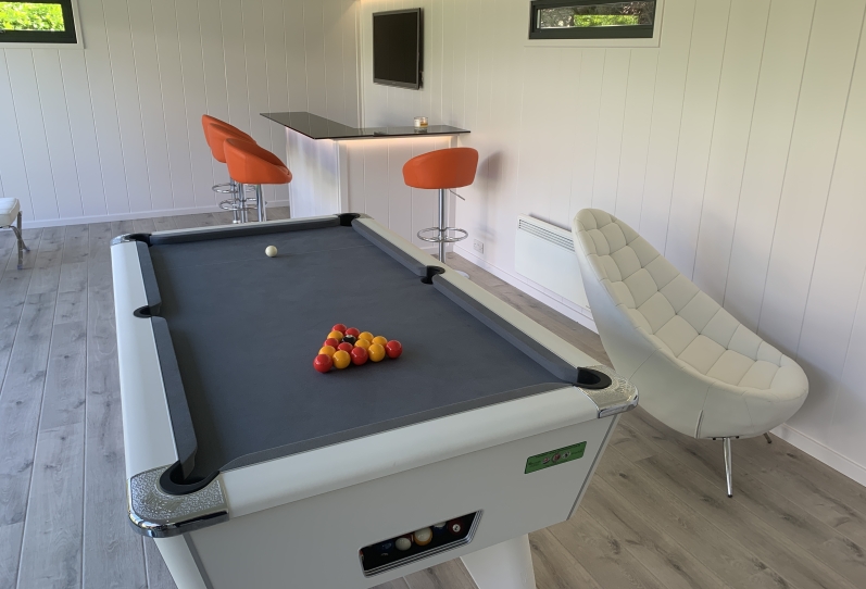 games room with pool table, bar, Tv and gaming chair in London