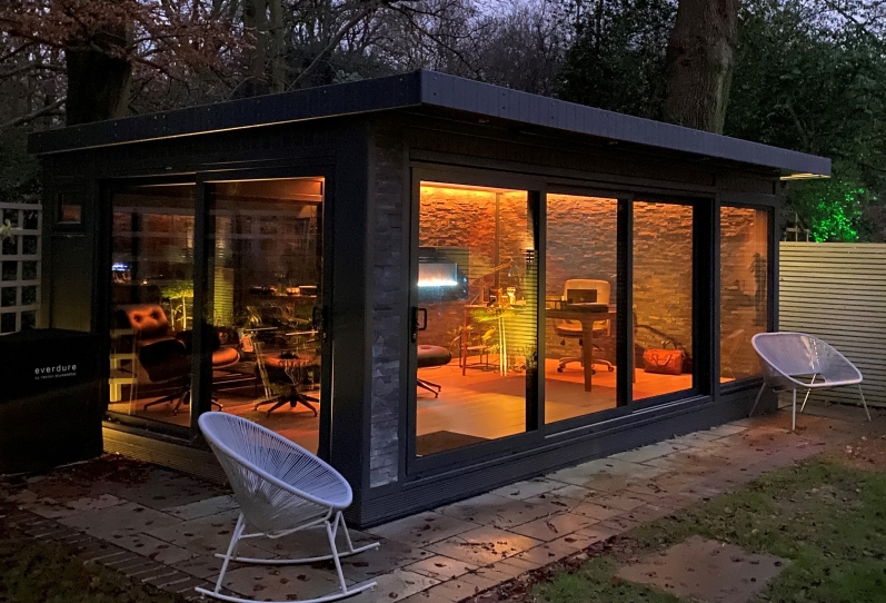 Ultimate Garden Office with Split face tiling inside and out, feature wall fireplace Bromley Night shot