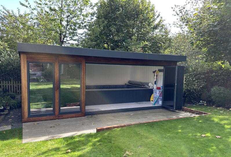 Iroko clad Endless pool with bi-fold doors in Hertfordshire