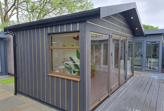 summer house , with Bronze metallic doors and windows ,  Millboard  envello cladding & gold decor inserts ref Designer collection