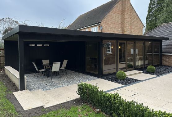 Bespoke entertainment room, black with mid-bronz doors side canopy in London